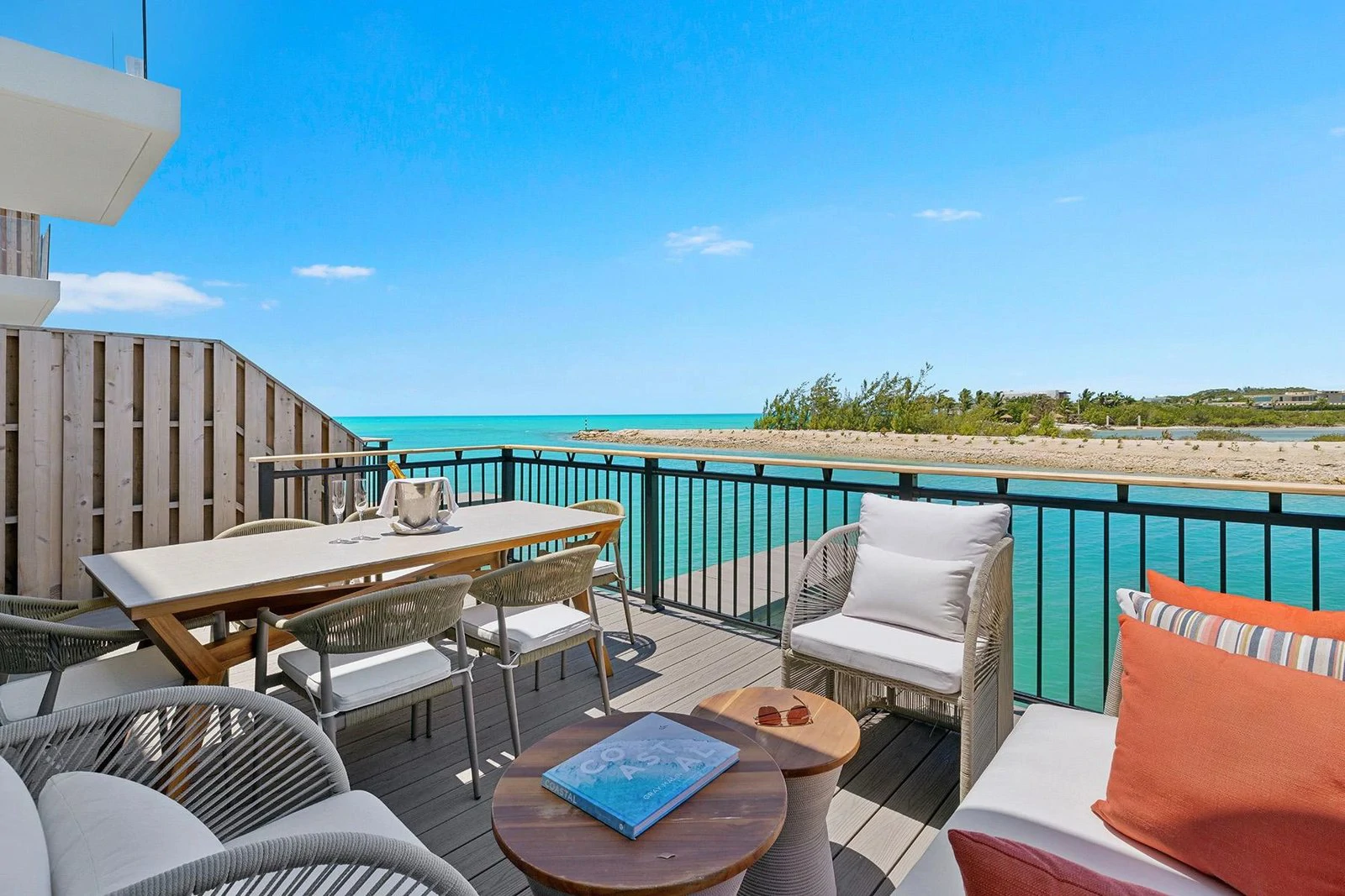 Furnished terrace overlooking turquoise water at Boathouse A10, South Bank